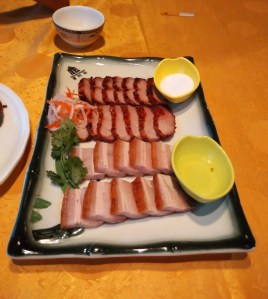 Two different kinds of roasted pork served with sugar and vinegar. 
