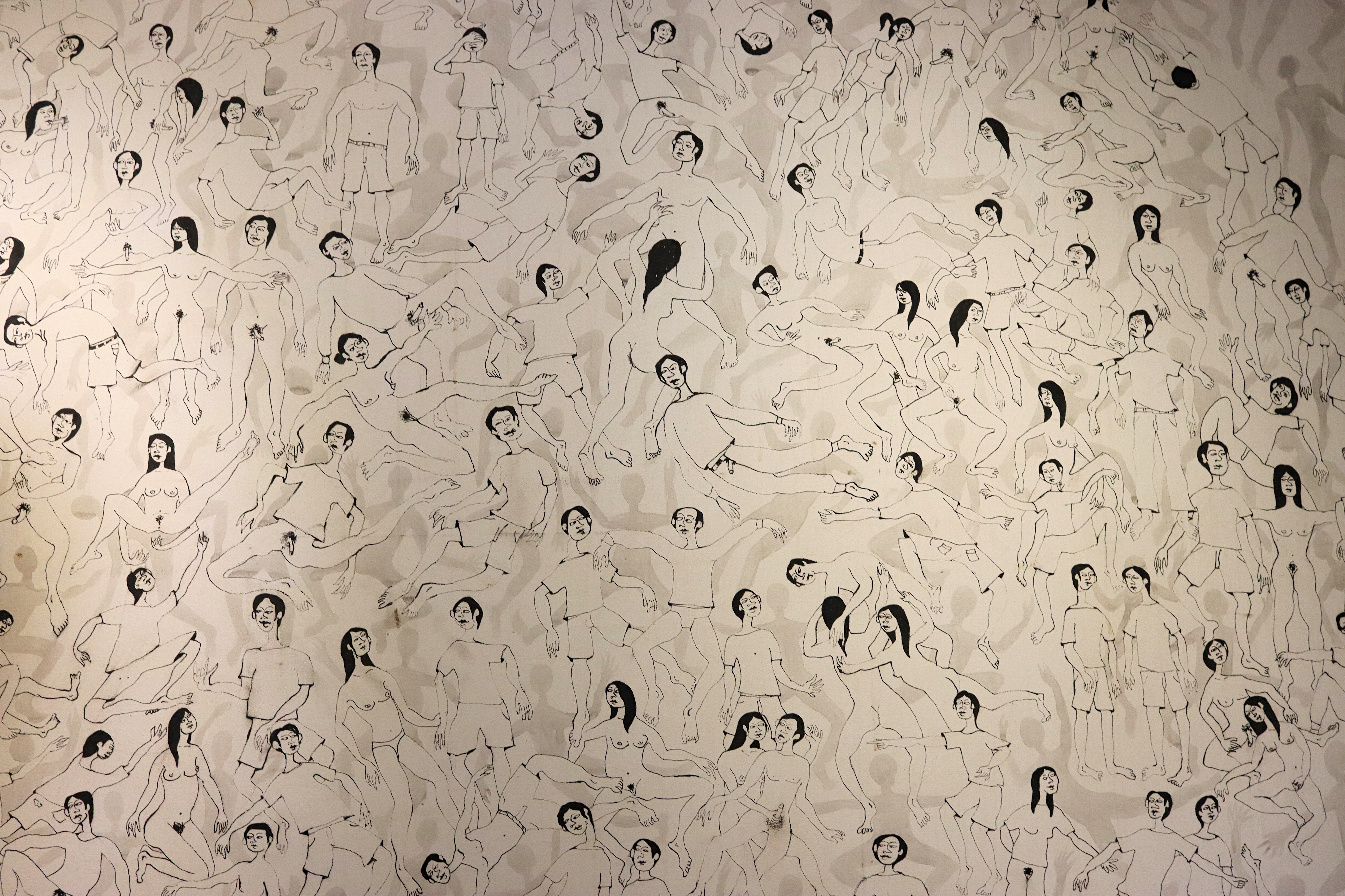 A mural featuring numerous illustrations of human figures in various poses, showcasing both male and female forms in a playful and abstract style.